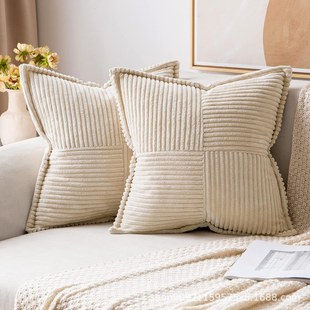Beige textured pillows on a sofa with a neutral background