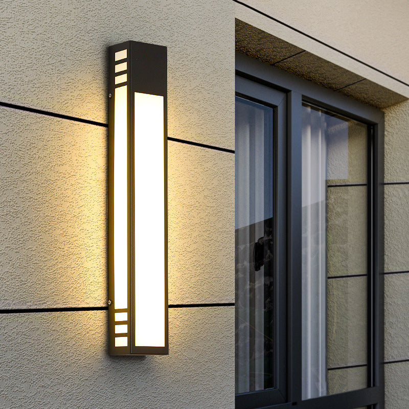 image Modern outdoor wall light fixture on a building exterior.