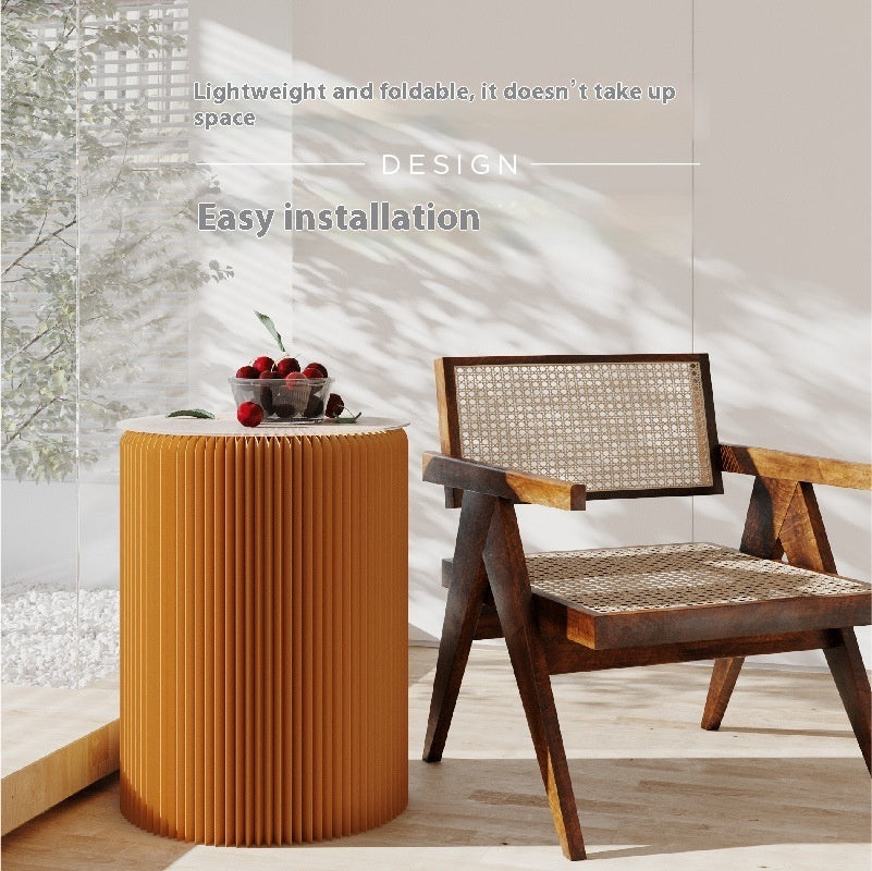 image Wooden chair and pleated side table on a wooden floor with text about design and installation.