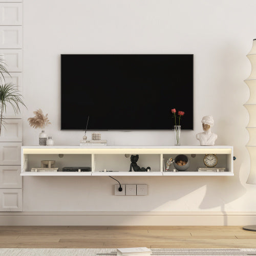 image Modern living room with a television mounted on the wall above a white entertainment console.