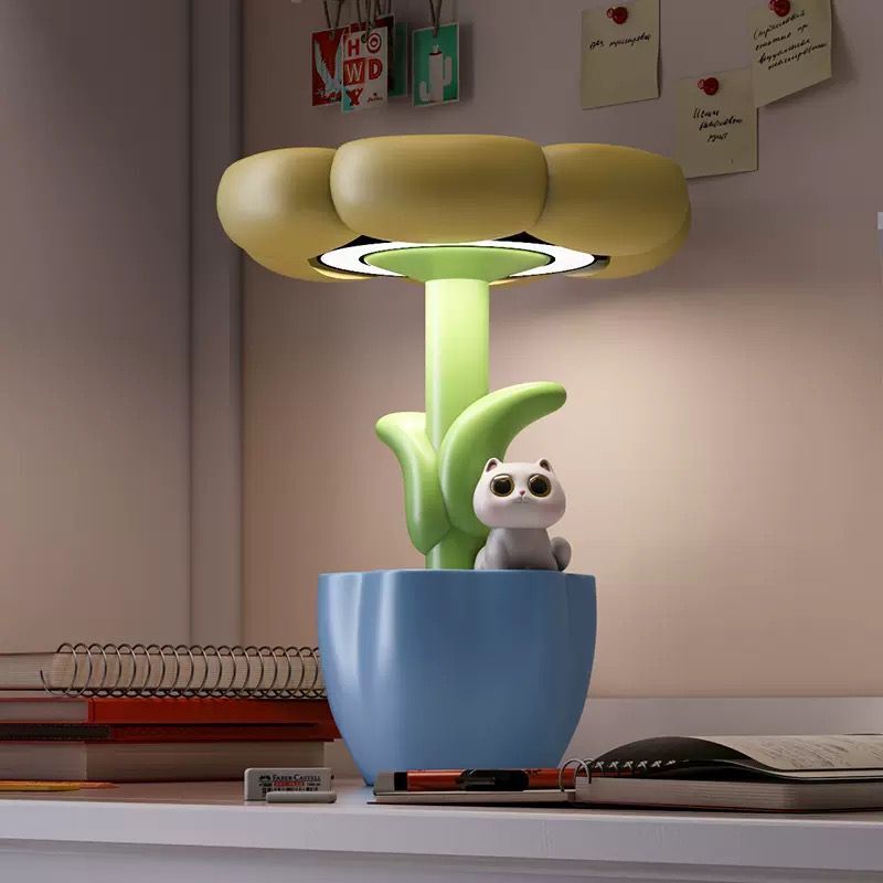 Decorative lamp with a blue base and green stem on a shelf.