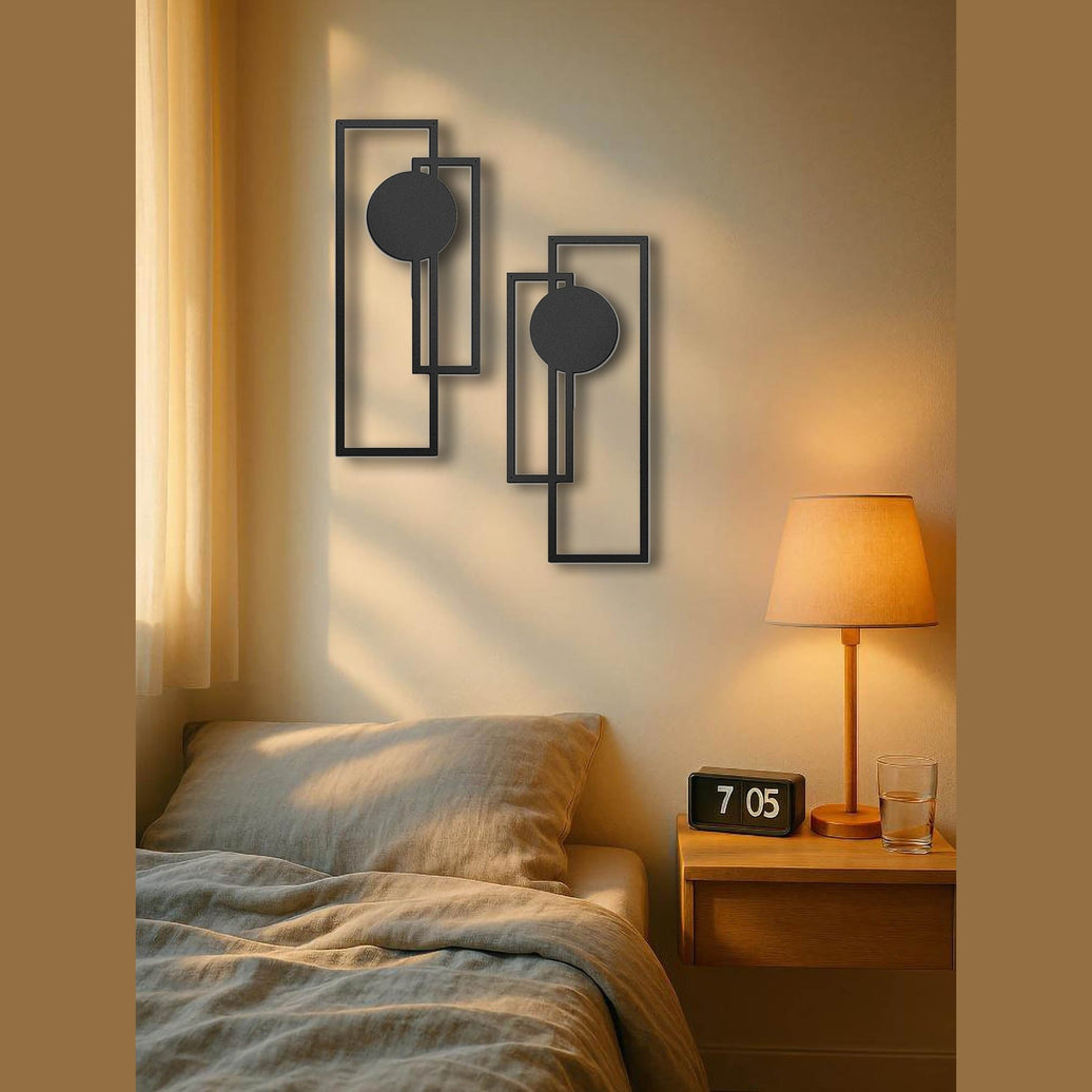 Modern bedroom with geometric wall art, bed, and nightstand with lamp.