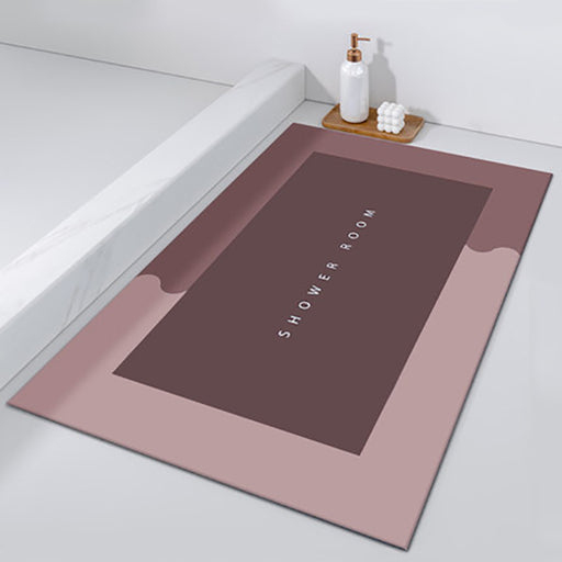Bath mat with 'SHOWER ROOM' text on a bathroom floor