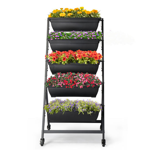 Black metal plant stand with five tiered planters filled with flowers on a white background