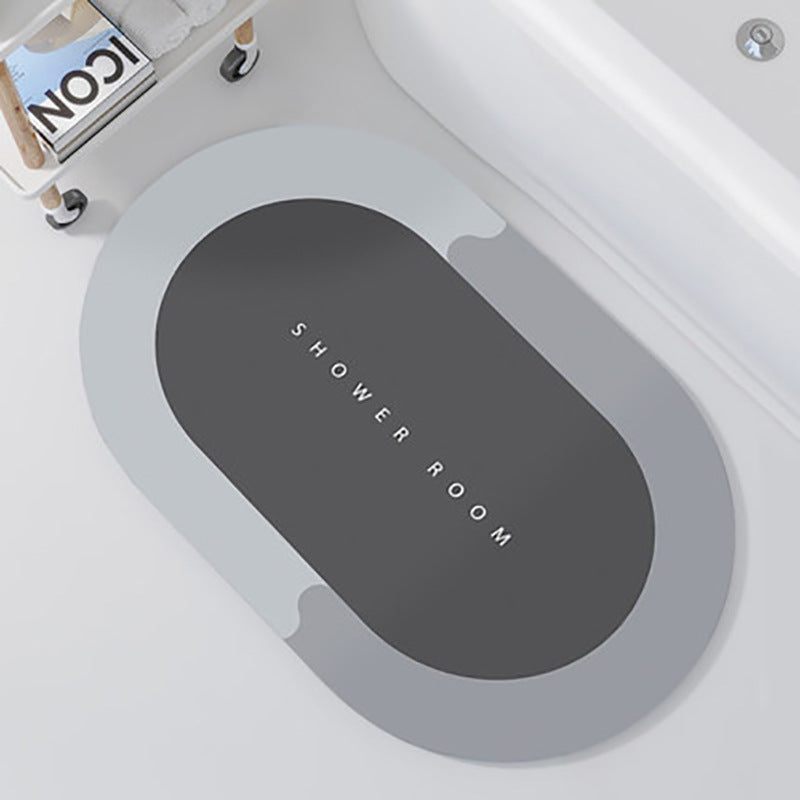Gray oval mat with 'SHOWER ROOM' text on a white bathtub