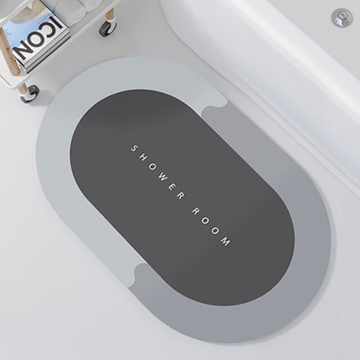 Gray oval mat with 'SHOWER ROOM' text on a white bathtub