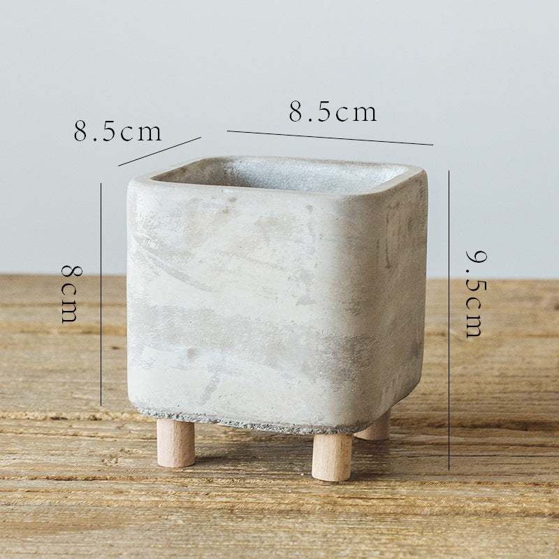 Concrete planter with dimensions on a wooden surface