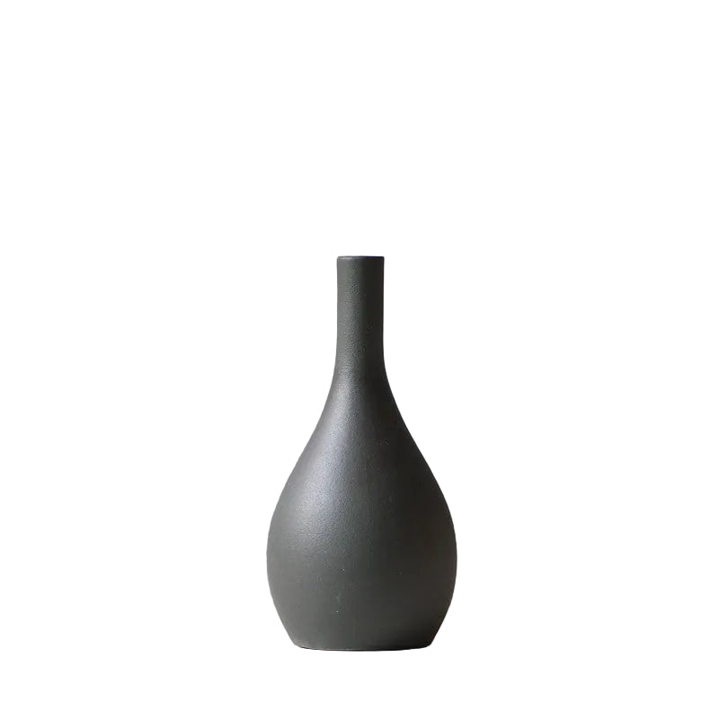 image Dark gray vase on a white surface with a gray background