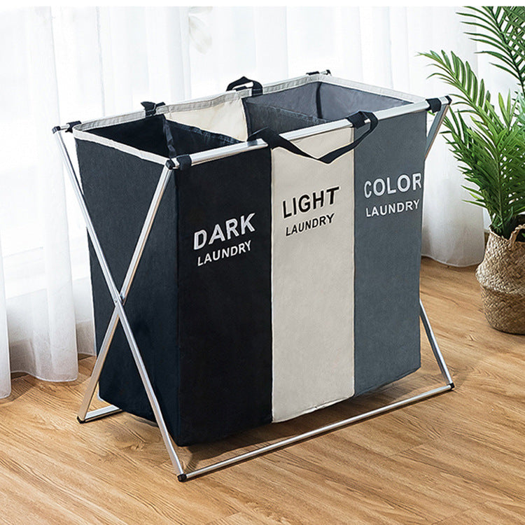 image Three-section laundry basket labeled 'Dark', 'Light', and 'Color' on a wooden floor.