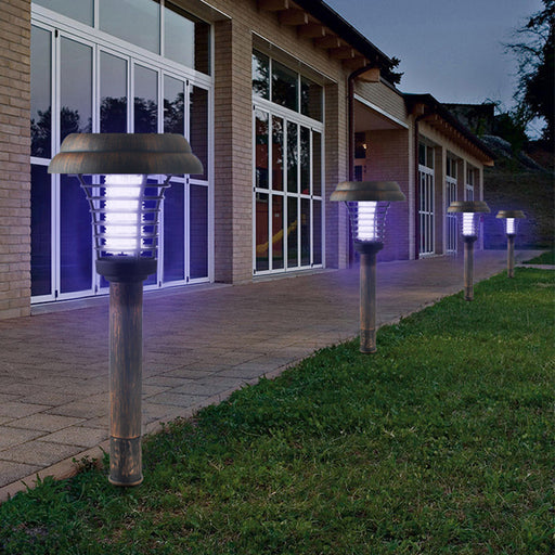 Solar-powered outdoor lamps illuminating a pathway in front of a building.