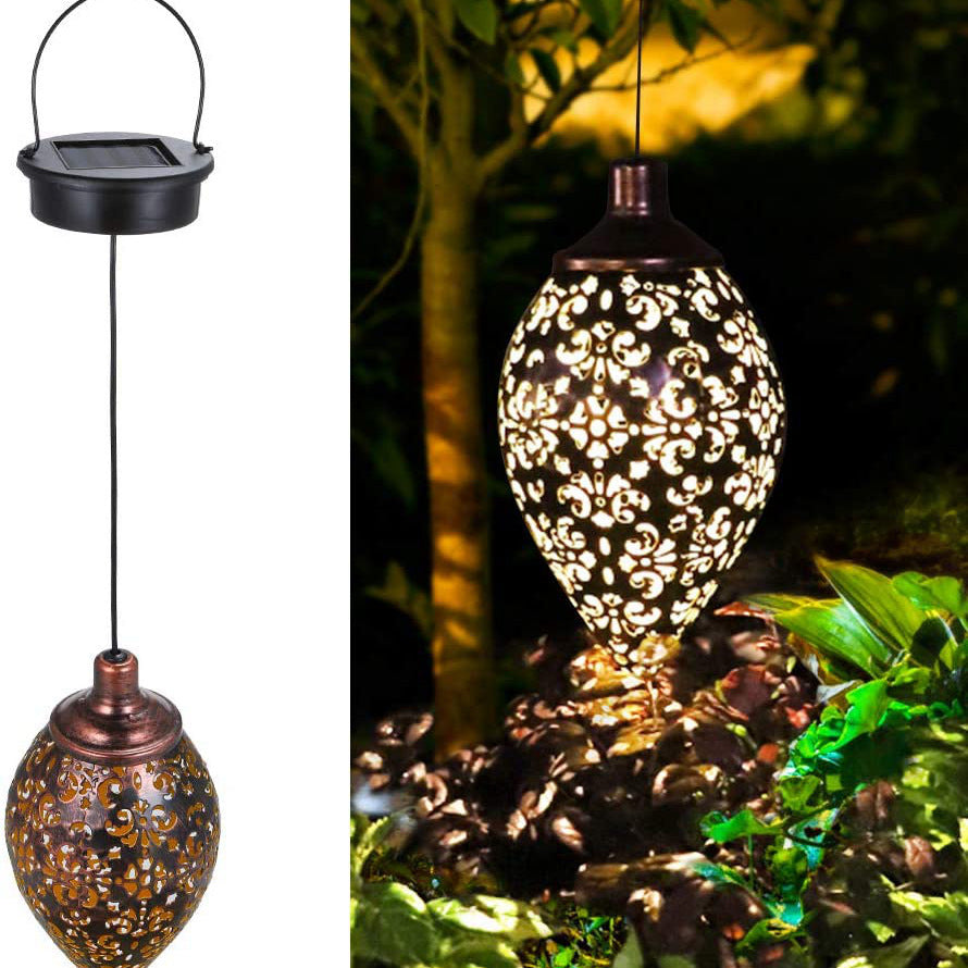 Decorative solar light with intricate design hanging outdoors.