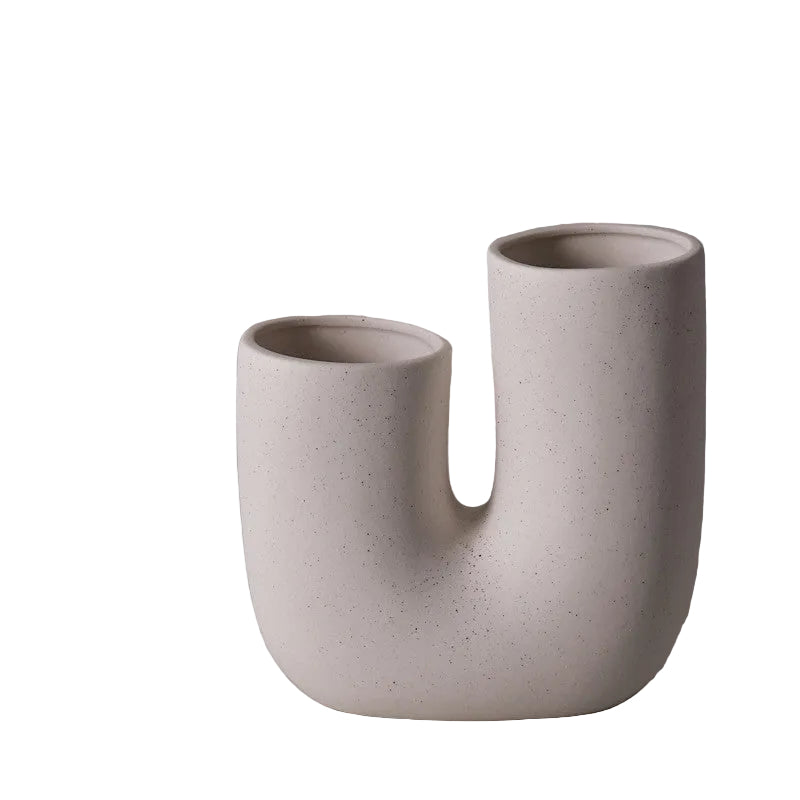Speckled beige ceramic vase on a gray background