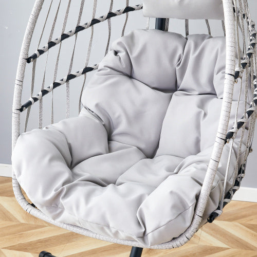 Gray cushion on a hanging chair with a wooden floor and light gray wall background