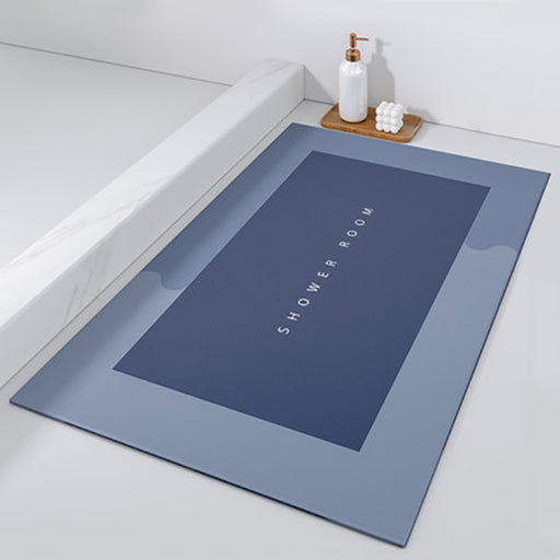Blue bath mat with 'SHOWER ROOM' text on a bathroom floor.