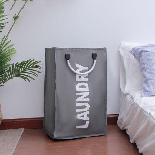 Gray laundry bag with 'LAUNDRY' text in a bedroom setting.
