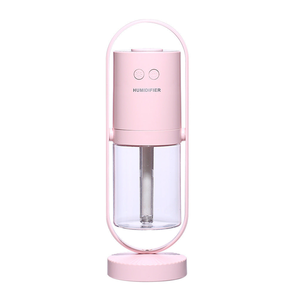 Pink humidifier with clear water tank on a white background