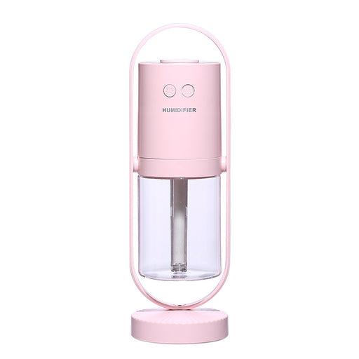 Pink humidifier with clear water tank on a white background