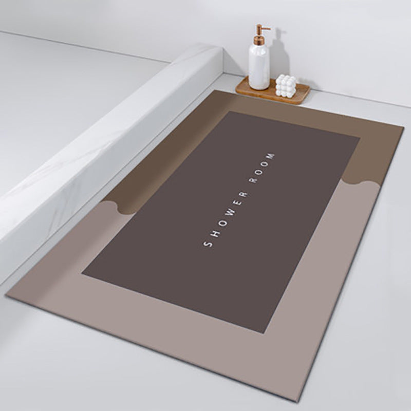 Bath mat with 'SHOWER ROOM' text on a bathroom floor