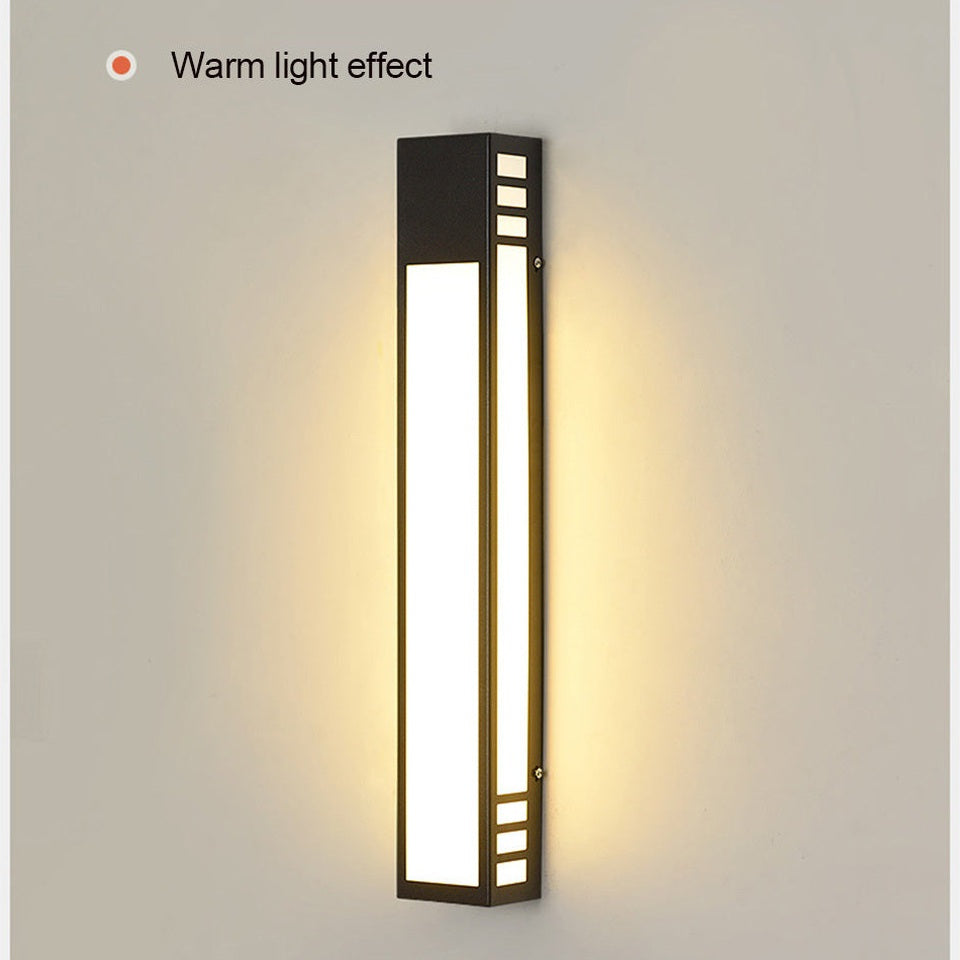 Wall-mounted light fixture with warm light effect on a neutral background