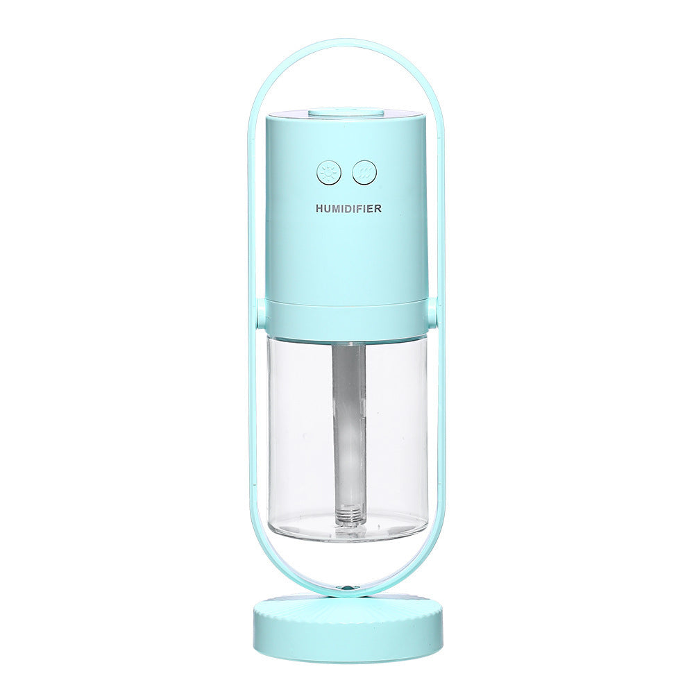 Portable humidifier with a light blue top and clear base on a white background