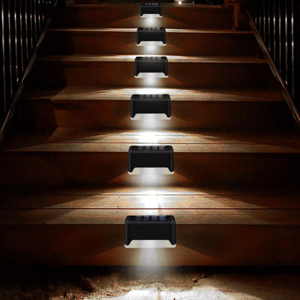 4 Solar Bright Led Deck Lights illuminating outdoor stairs for safety and elegance at night.