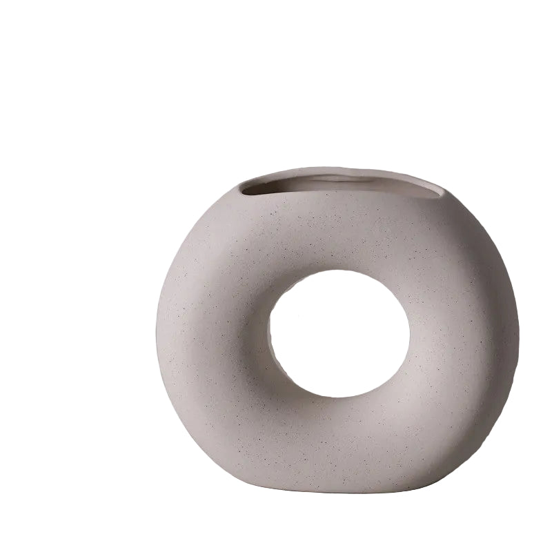 image White ceramic vase with circular design on a gray background