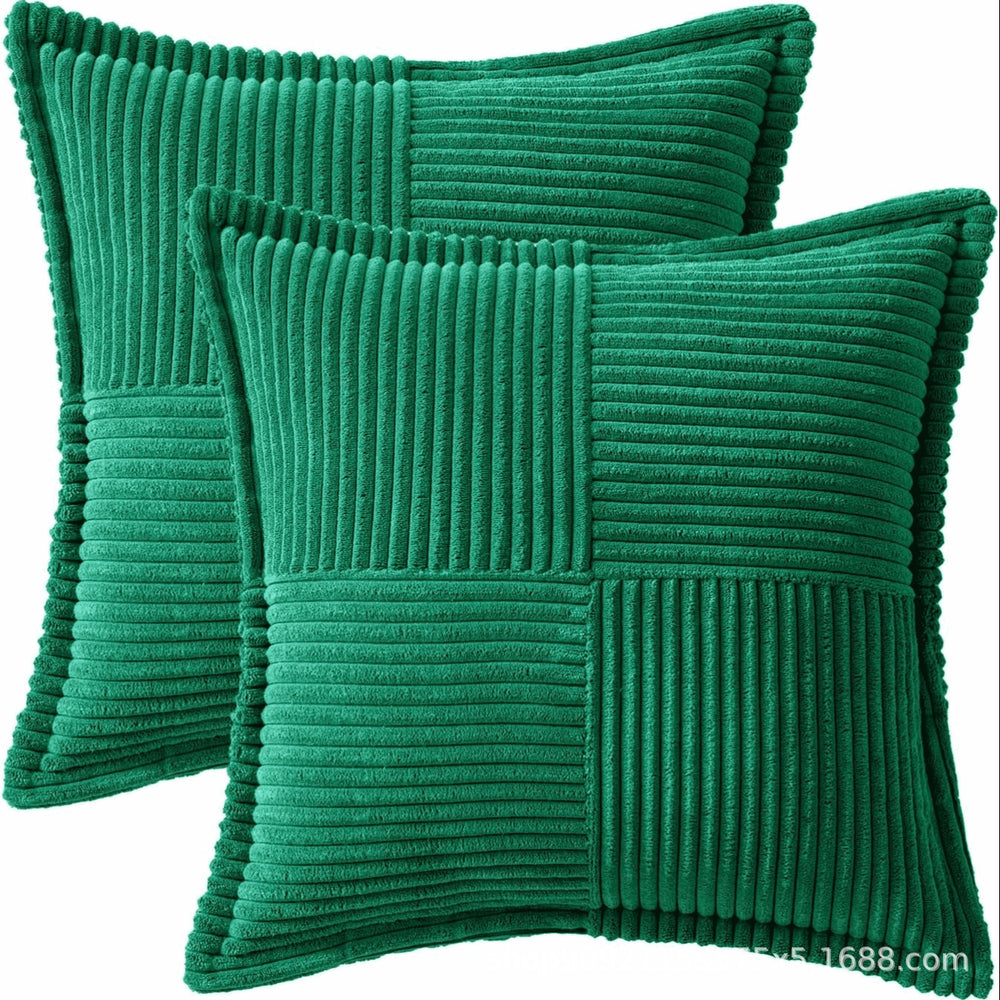Two green ribbed textured pillows on a white background