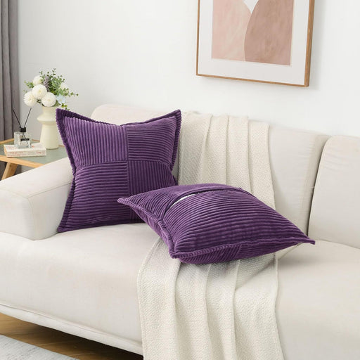 Purple textured pillows on a white sofa with a neutral decor background