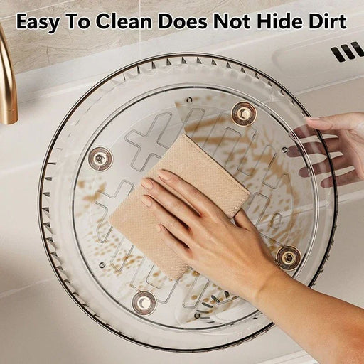 Person cleaning a glass lid with a cloth on a kitchen counter.