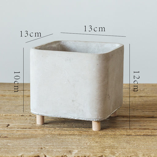Concrete planter with dimensions on a wooden surface