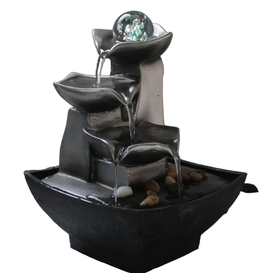 Tabletop water fountain with tiered design on a marble surface