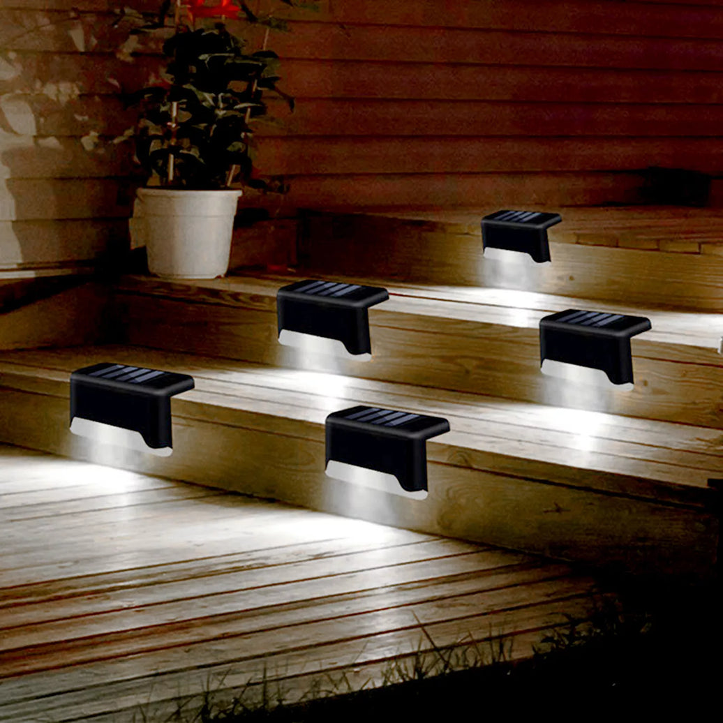 4 Solar Bright Led Deck Lights illuminating outdoor stairs at night for enhanced safety and ambiance.