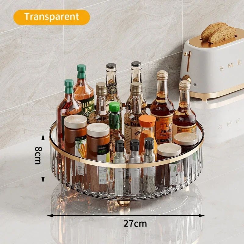 Transparent round tray with various bottles on a light gray surface.