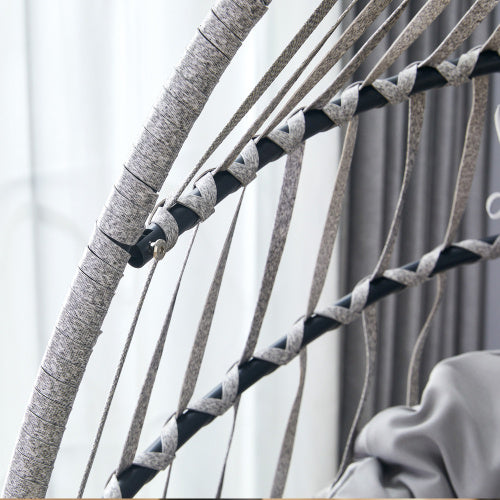 Close-up of a woven black and gray hammock with a blurred background