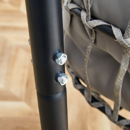 Close-up of a black metal rod with screws on a blurred background